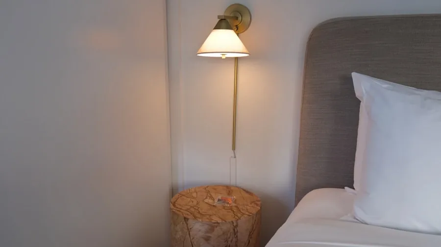 bedroom wall sconce above nightstand