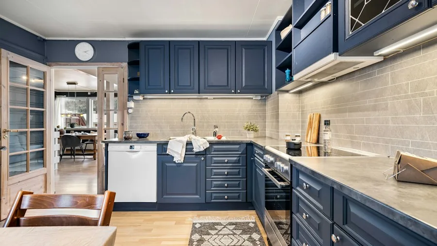 Century Old Kitchen Gets Modern Storage Makeover: What Shoppers Should Know 2 blue kitchen cabinets with gold hardware