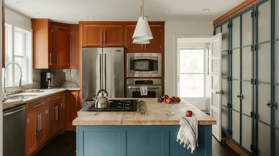 Brown Kitchen Cabinets Get a Color-Forward Makeover and What Shoppers Should Know 3 blue painted kitchen island