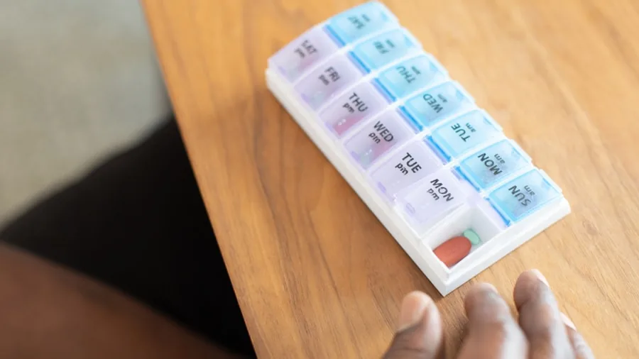 Dollar Tree Pill Organizer Hack Keeps Medication Visible on Your Countertop and Fridge 2 colorful pill organizer daily medication