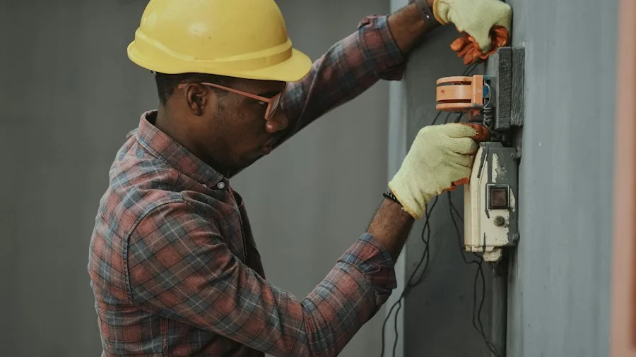 Amazon Basics Smart Light Switch Hits $15: What Shoppers Need to Know About Voice Controlled Lighting 2 electrician installing wall switch