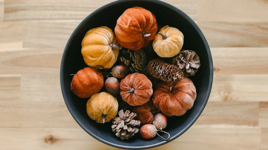 DIY Toilet Paper Roll Pumpkins: A Creative Upcycling Trend for Fall Decorating 3 finished mini pumpkins displayed in bowl