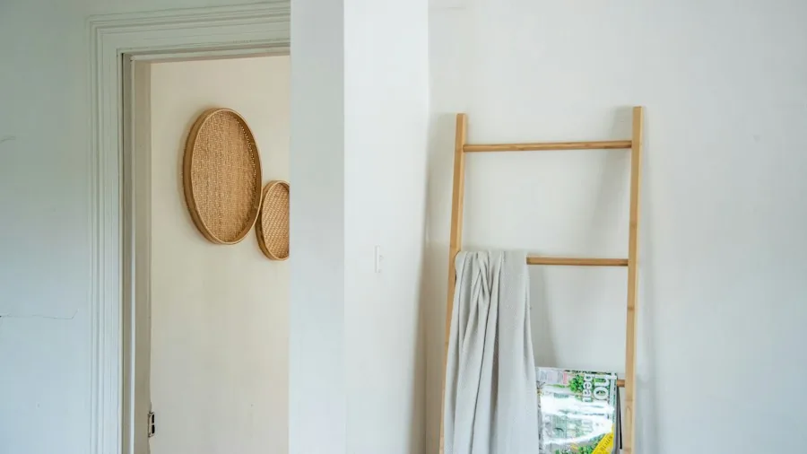 DIY Wood Towel Rack Replaces Builder Grade Fixtures in Your Bathroom 3 finished wood towel rack mounted on wall