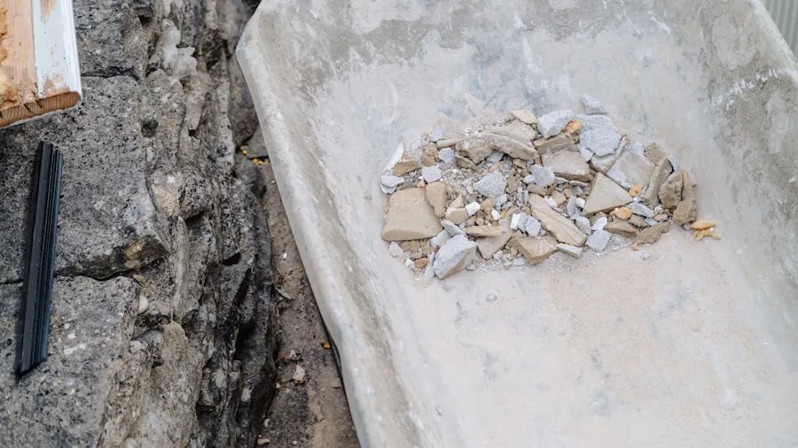 hands mixing concrete in wheelbarrow