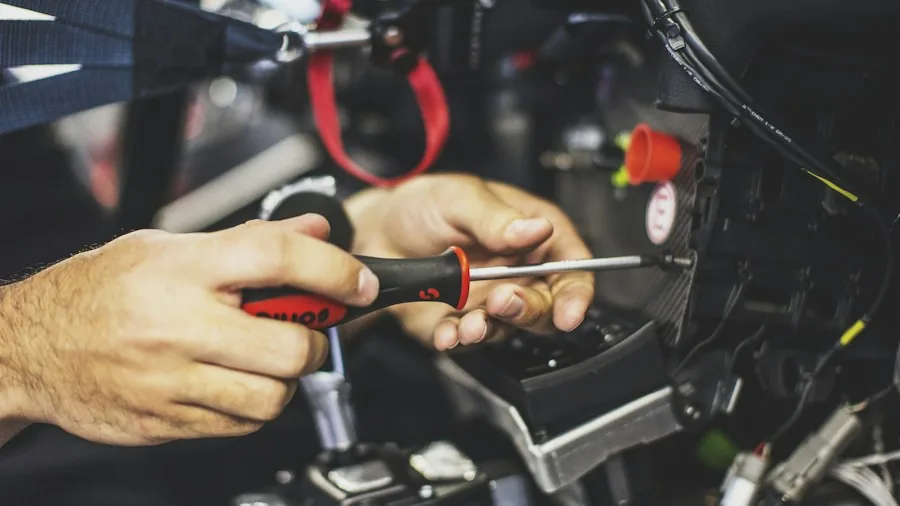 Pliers Hidden Features What Buyers Should Know 3 mechanic hands using pliers on fasteners