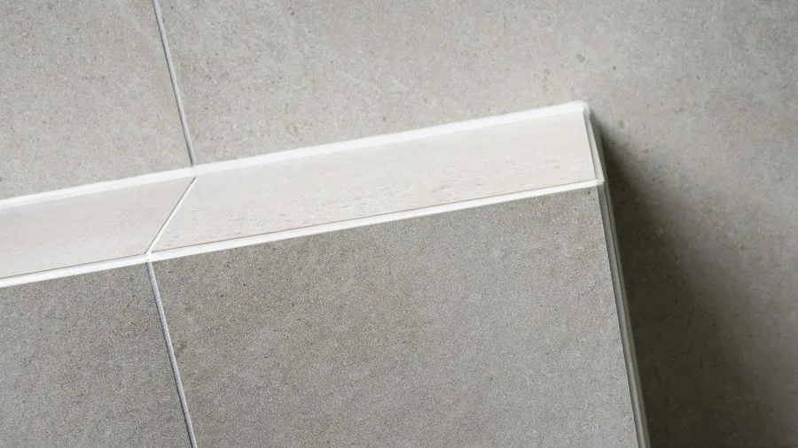 Budget Bathroom Upgrade: How to Refinish a Bathtub and Add Stone Tiles in One Weekend 3 stone tiles tub apron detail
