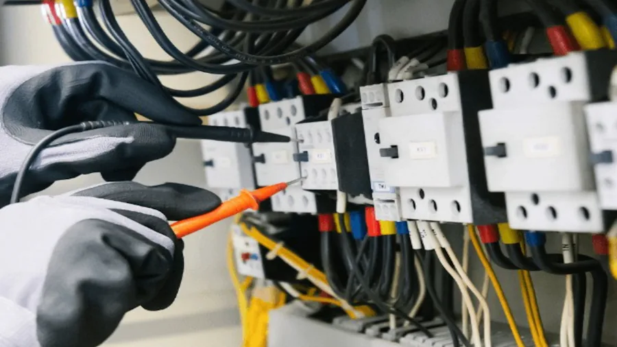 Klein Tools Launches New Voltage Tester with Signal Strength Display: What You Need to Know 2 technician working with electrical wiring closeup