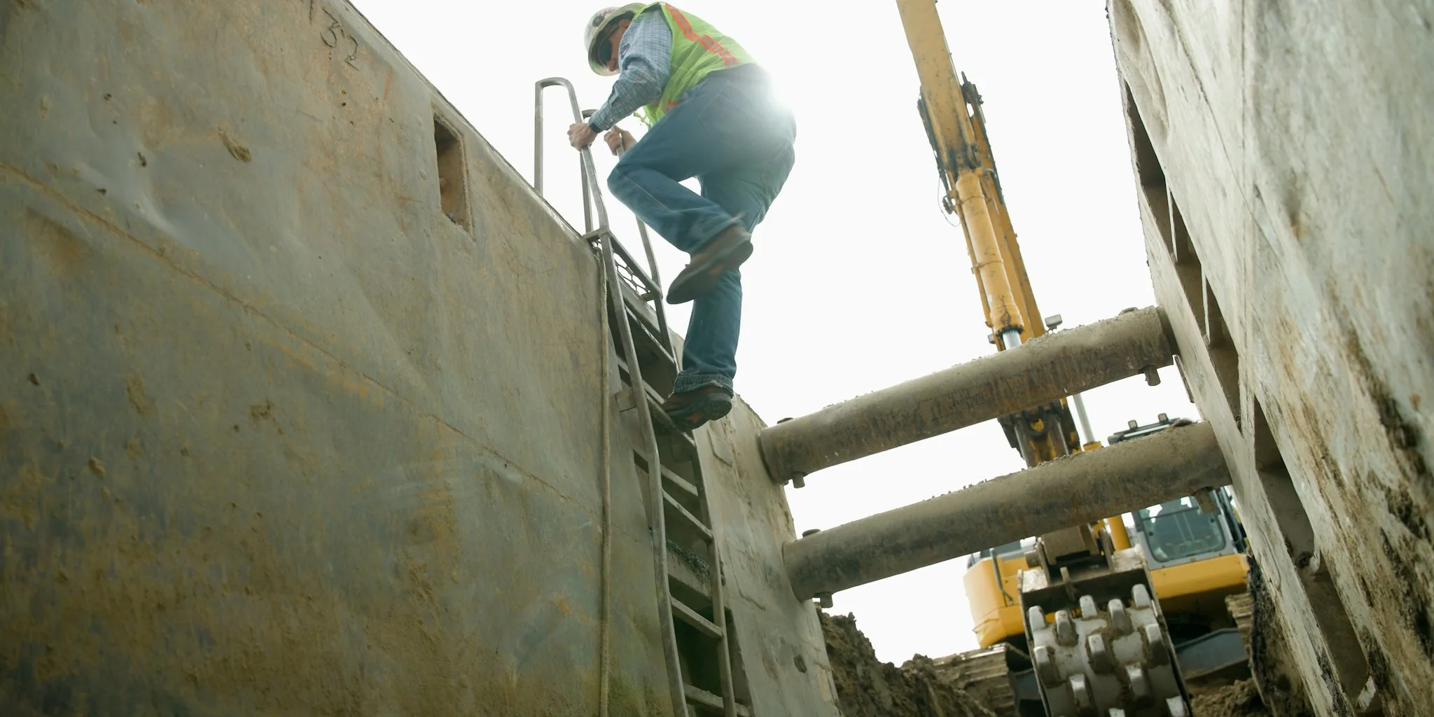 utility worker drilling structural material