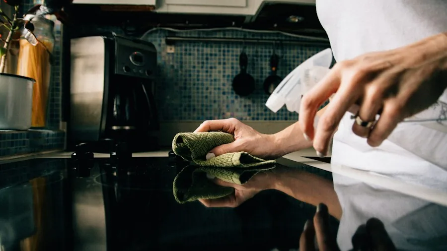 7 Tips to Keep Your Glass Cooktop Scratch-Free and Looking New 3 wiping glass stovetop clean