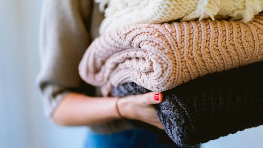 Fall Dryer Upgrade Trends: What Buyers Should Know Before Shopping 2 woman folding autumn sweaters blankets